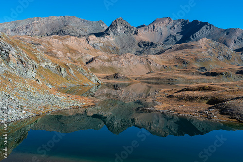 Leita lake with water reflection, Rosset, Leynir, Bes, Taou Blanc mountains peak. Gran Paradiso National Park landscape in autumn. Nivolet