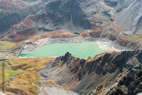 Serrù Lake and dam (Ceresole Reale, Orco Valley) Gran Paradiso National Park. colorful mountain landscape in autumn