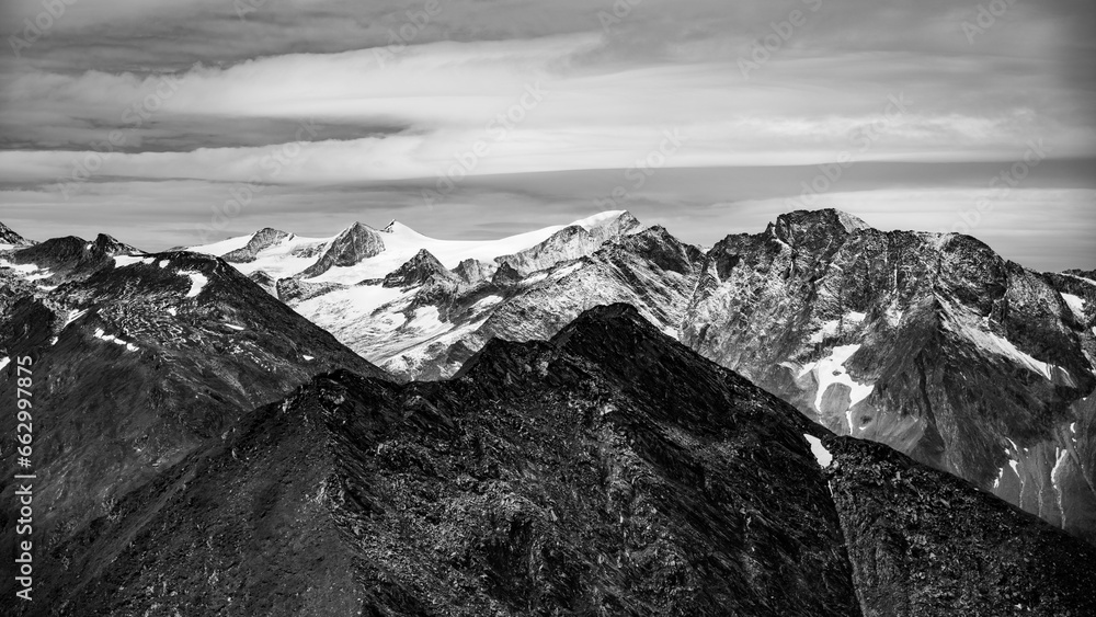 Majestic alpine panorama with glacier mountain of Grossvenediger. The main peak of the Venediger Group in Hohe Tauern mountain range. Austrian Alps, Austria. Black and white photography.