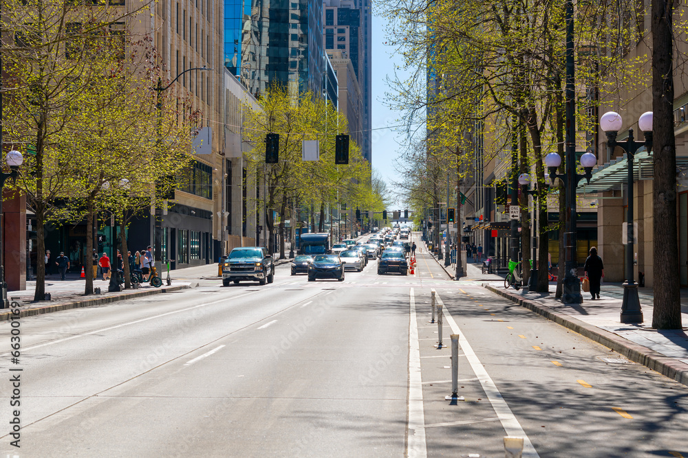 Street view of 4th Avenue, a commercial street of shops and restaurants through the city center of downtown Seattle, Washington.