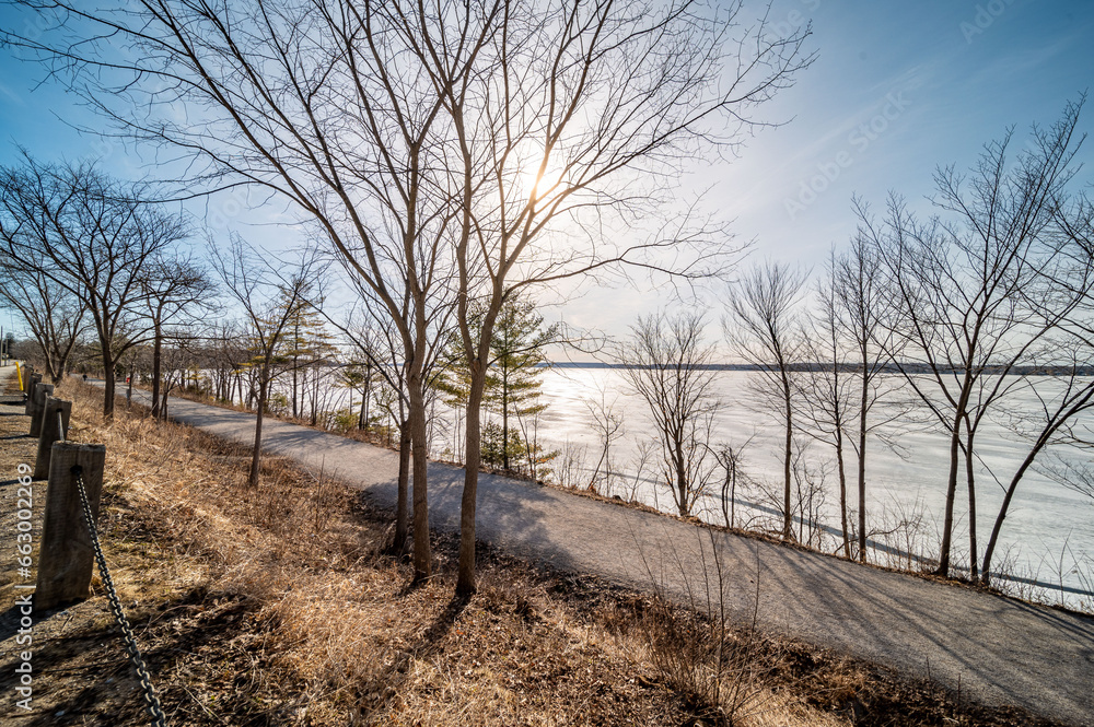 Embrace the serene beauty of Lake Simcoe in winter with this stunning image of its frozen surface. A symbol of the season's quietude and majestic charm, this picture is perfect for themes of Canadian 