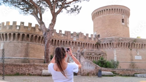 Girl photographing the castle of Ostia Antica