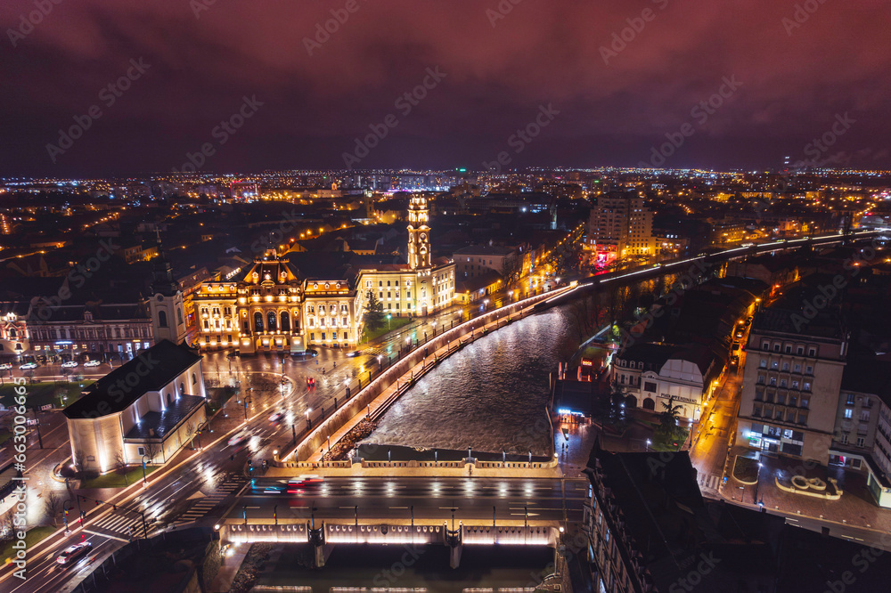Aerial art nouveau historical a scenic cityscape with a meandering river flowing through the historic streets of Oradea captured from a bird's eye view incity Oradea, Bihor, Romania