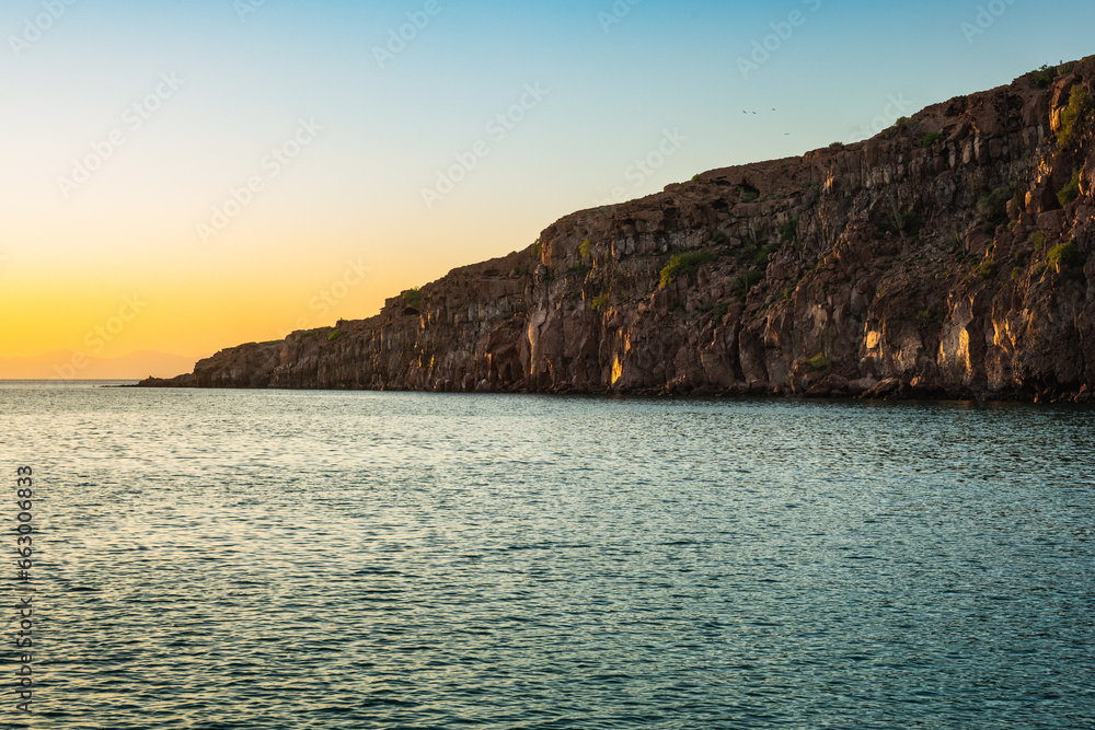 Autumn Sunset over Espíritu Santo: Calm Waters and Rugged Cliffs