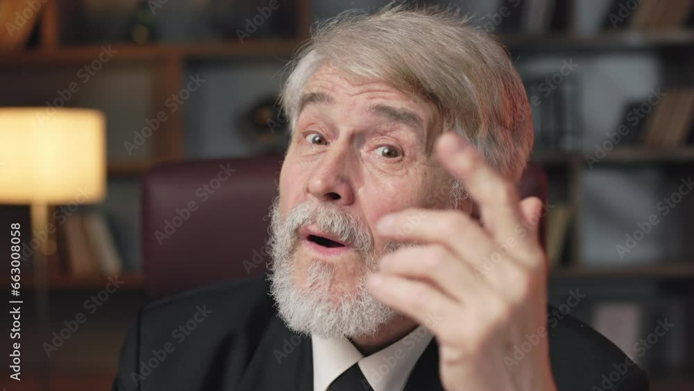 Senior bearded man in formal outfit pointing up index finger when shaping new idea at workplace. Experienced entrepreneur coming up with modern method of improving productivity of corporation. Senior bearded man in formal outfit pointing up index finger when shaping new idea at workplace. Experienced entrepreneur coming up with modern method of improving productivity of corporation.