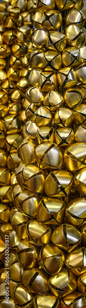 Closeup of gold jingle bells made into a decorative Christmas Tree for home decoration
