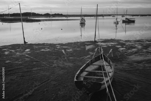 Small fishing boats stuck in a harbour at low tide