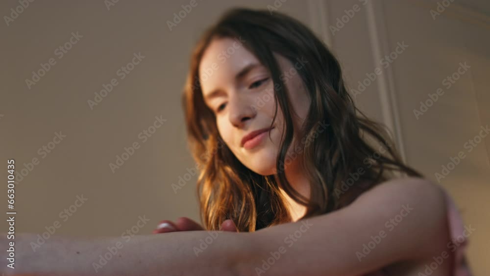 Closeup girl applying lotion on smooth skin in sunlight. Serene woman enjoying Closeup girl applying lotion on smooth skin in sunlight. Serene woman enjoying