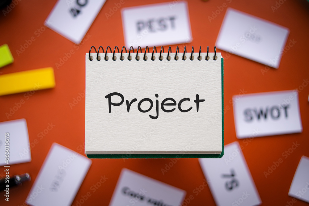 There is notebook with the word Project. It is as an eye-catching image.