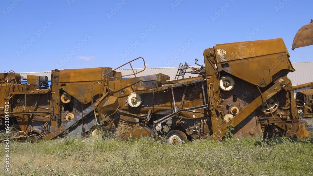 Damaged agricultural machinery destroyed by artillery fire (panorama, camera moving from left to right). War in Ukraine Damaged agricultural machinery destroyed by artillery fire (panorama, camera moving from left to right). War in Ukraine