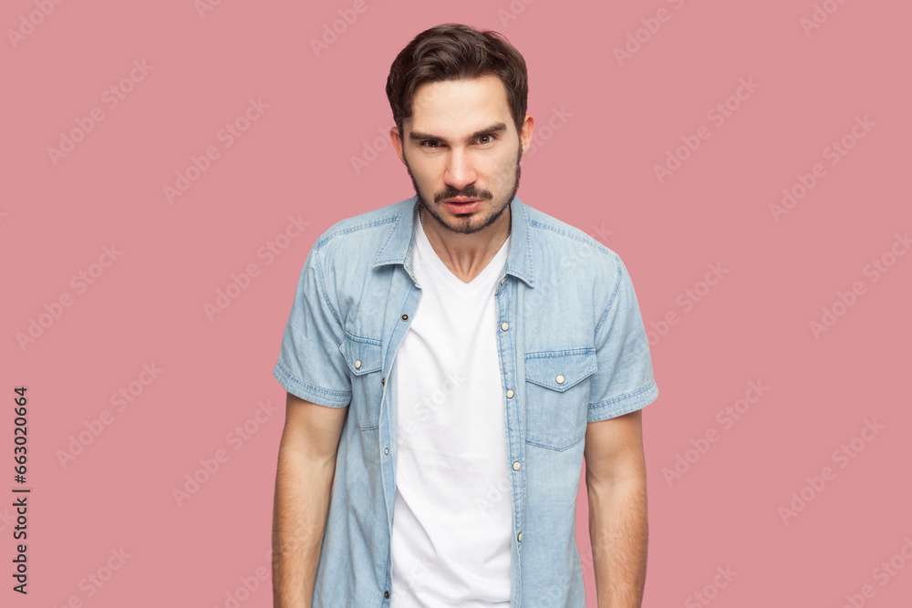 Φωτογραφία Portrait of bearded man in blue casual style shirt standing frowning, having grumpy angry look, dissatisfied with misbehavior of somebody