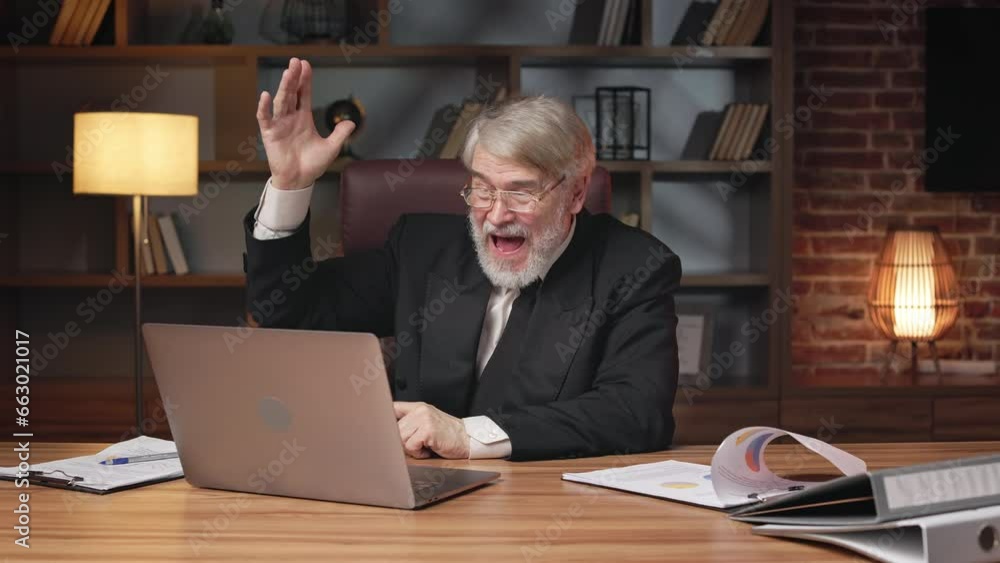 Happy aged businessman in formal suit rejoicing at work results on portable computer in modern office. Overjoyed professional employee getting excited about great news received via email account. Happy aged businessman in formal suit rejoicing at work results on portable computer in modern office. Overjoyed professional employee getting excited about great news received via email account.