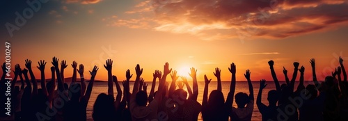 Hands to heaven, group of people with their hands up looking at the sunset 