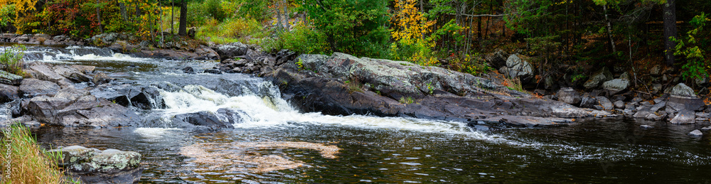Obraz premium Waterfalls flowing into Lake of the Falls in Mercer, Wisconsin in September