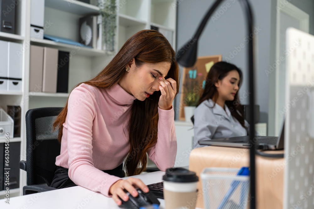 Exhausted Asian young businesswoman overwork late in office workplace. Exhausted Asian young businesswoman overwork late in office workplace.