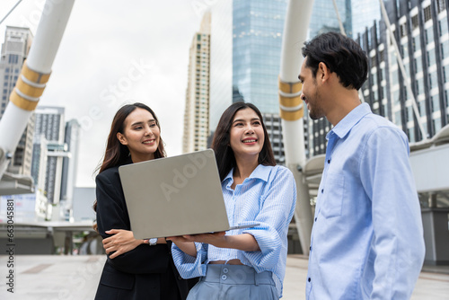 Group of Asian businessman and businesswoman work outdoor in the city.  © Kawee