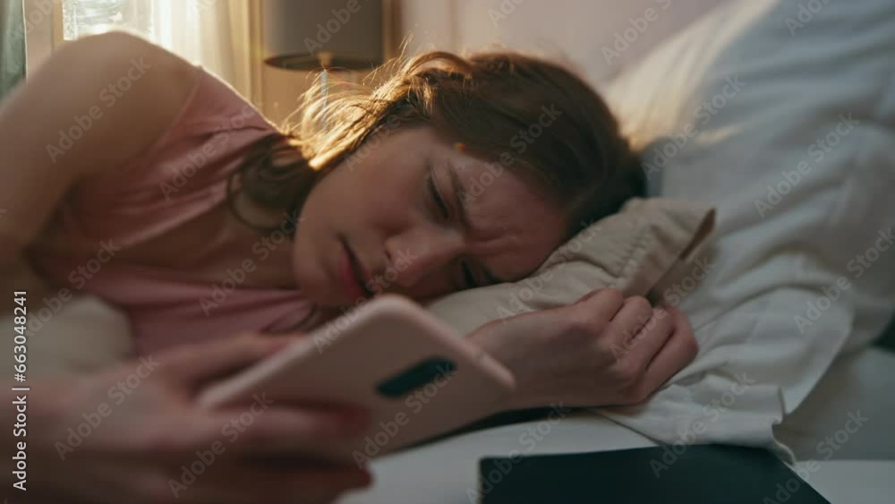 Annoyed girl turning alarm clock off closeup. Upset sleepy woman waking up early Annoyed girl turning alarm clock off closeup. Upset sleepy woman waking up early