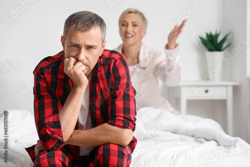 Upset mature man with his q...