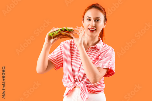 Young redhead woman with ta...