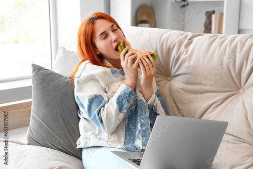 Young redhead woman with la...