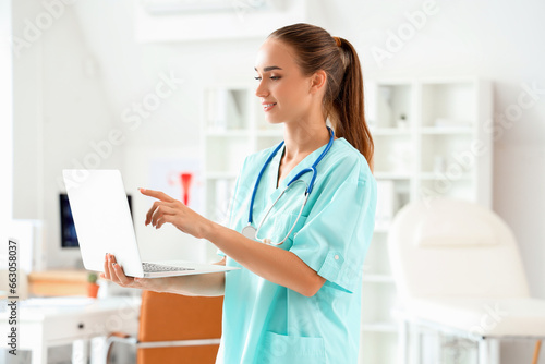 Female medical student studying with laptop at university