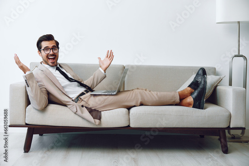 Video man modern business sitting couch home handsome call sofa networking smiling online laptop