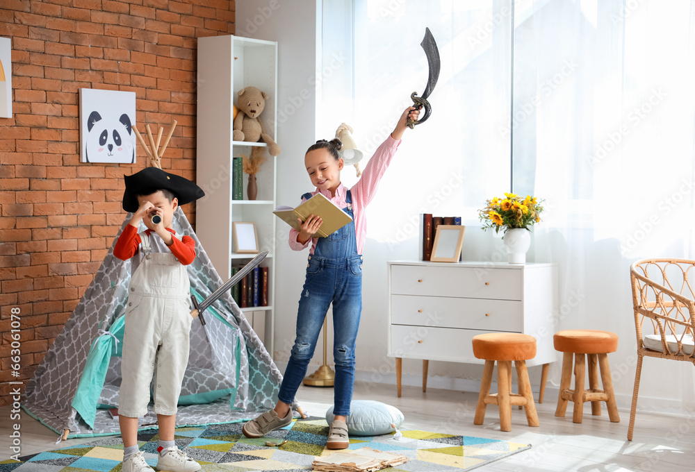 Cute little children playing with adventure book at home - obrazy, fototapety, plakaty 