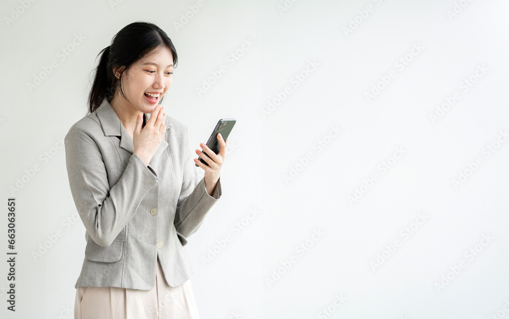 Young asian woman using mobile phone, standing over white background Young asian woman using mobile phone, standing over white background