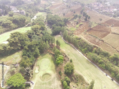 Bird's eye view of a Golf Courses area with cityscape and trees, Bojong Koneng - Bandung, Indonesia. Drone Photography, Aerial Photography, Landscape, Sport Fields, Green Field aerial photo