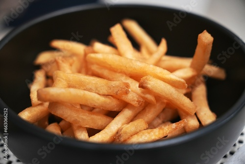 The Salted French fries in white bowl on a wooden tray