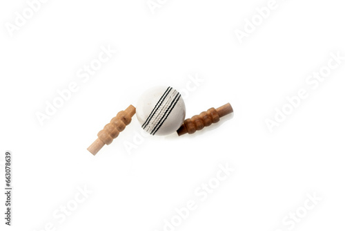 Cricket ball and bails are on isolated white background