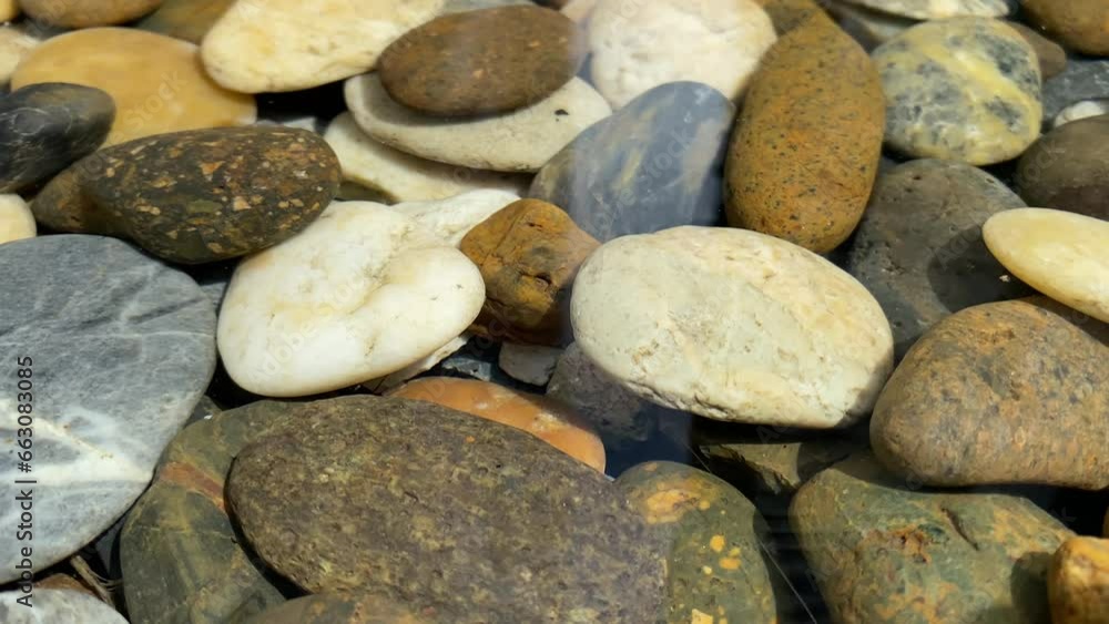 Close up background view pebble rock stones under clear water outdoor decoration at garden daytime. peace and calmness concept Close up background view pebble rock stones under clear water outdoor decoration at garden daytime. peace and calmness concept