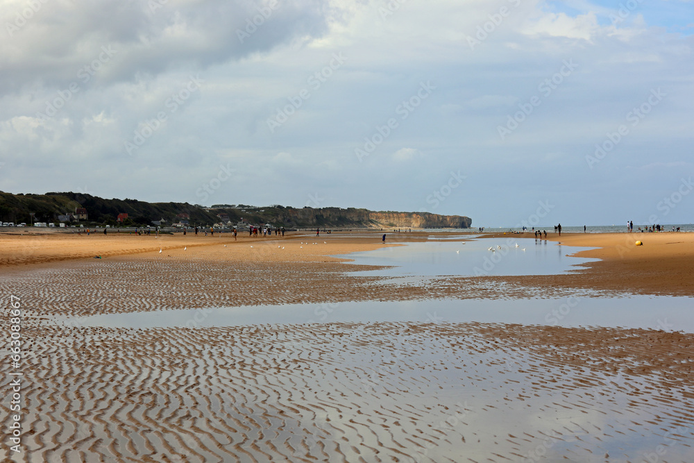 beach with water after summer storm and people in the background beach with water after summer storm and people in the background