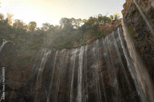 Majestic Ascent: Tumpak Sewu Waterfall from Below