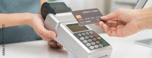 Pay, cashless technology concept, customer using credit card to buy at counter cashier, holding wireless bank machine for payment, paying money to transfer cashless at retail shop, department store. photo
