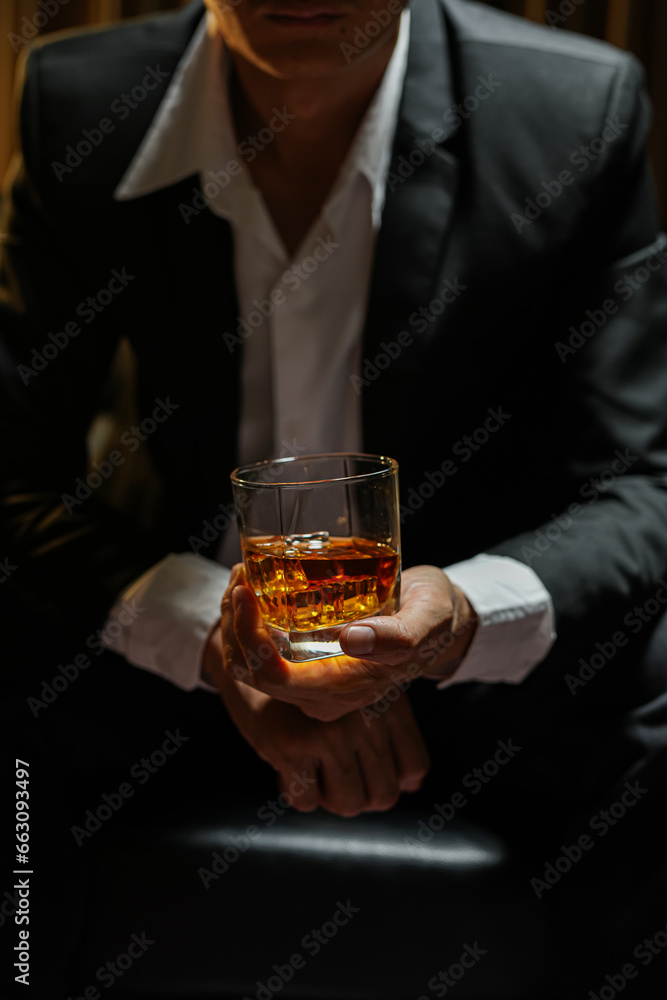 businessmen holding a glass of whiskey businessmen holding a glass of whiskey