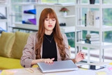 Asian professional successful thoughtful young female businesswoman creative graphic designer employee in casual fashionable suit blazer outfit sitting thinking solution ideas.