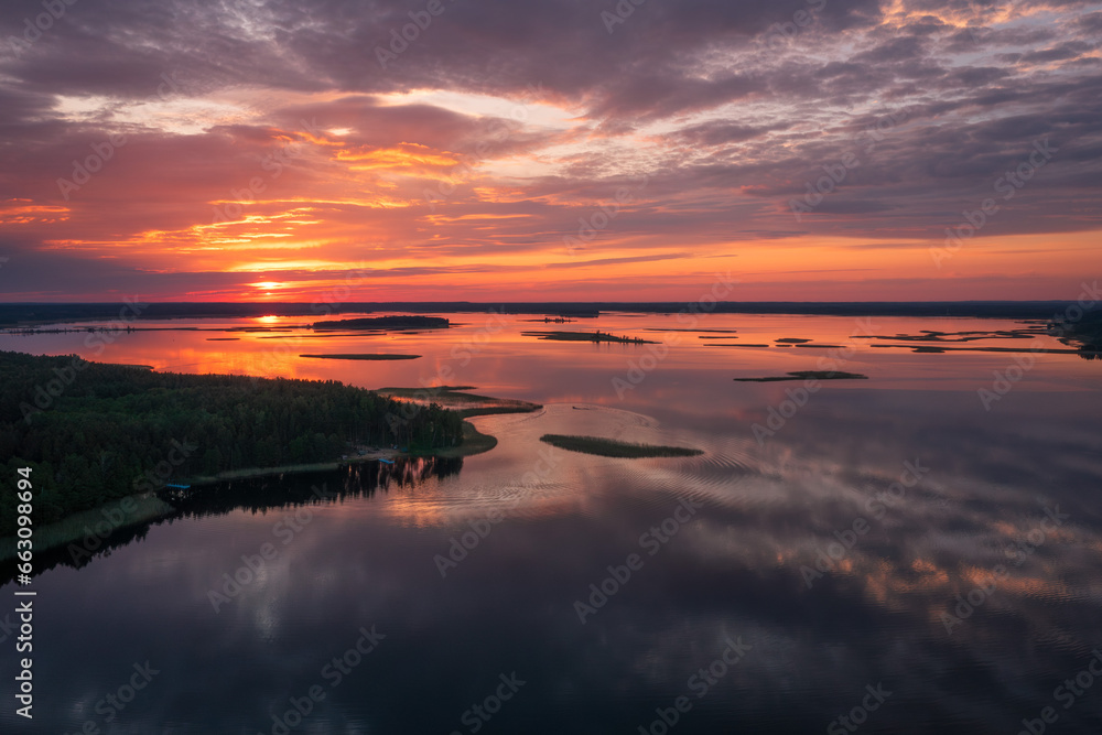 Aerial view of nature on sunset. Lake Snudy, Nation Park Braslav Lakes. Aerial view on lake and forest. Tourist sites on Lake Snudy, camping.