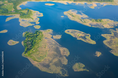 Obraz na płótnie Aerial view of nature of National Park Braslav Lakes on sunny day. Large and small islands on Lake Snudy covered woods or reeds. w salonie