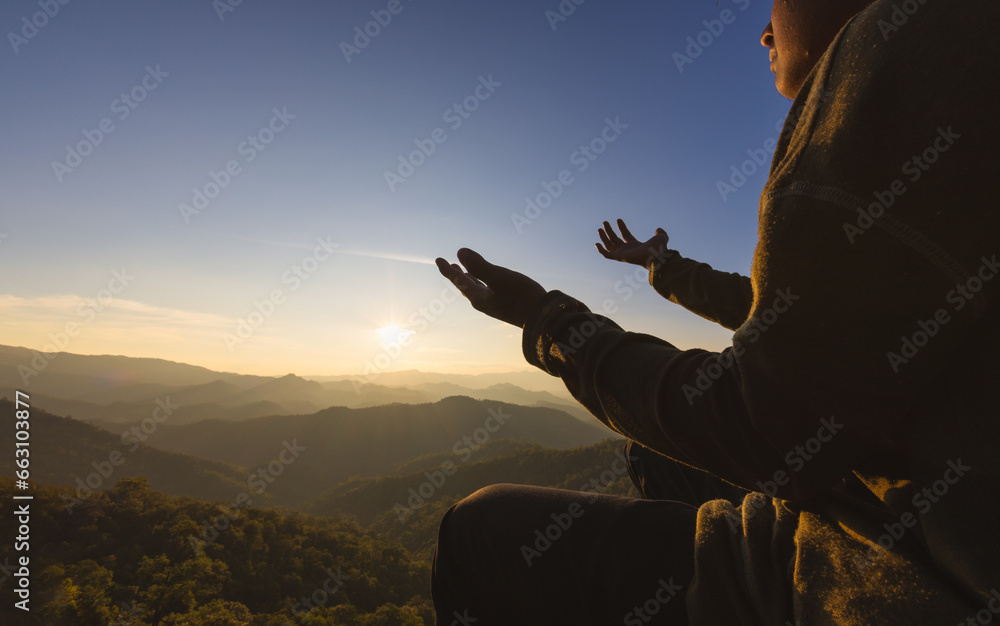 Fototapeta premium Silhouette of christian man hand praying,spirituality and religion,man praying to god. Christianity concept. Pray for god blessing to wishing have a better life.