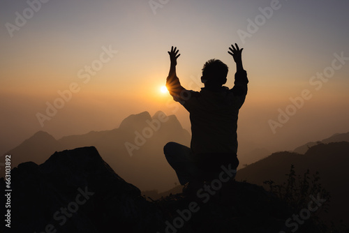 Silhouette of christian man hand praying,spirituality and religion,man praying to god. Christianity concept.  Pray for god blessing to wishing have a better life. photo