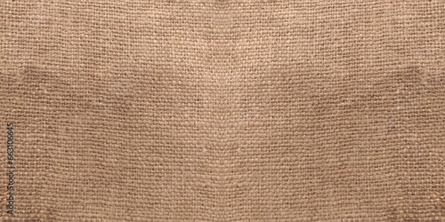 Top view of natural brown hessian cloth or gunny sack. Hessian cloth is an inexpensive fabric or garment made of hessian or burlap formed of jute, coarsely woven fabric. Sackcloth textured background