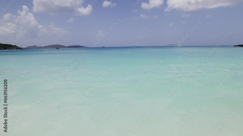 Tranquil aerial wide shot of water crashing on the beach shore sand blue sky white clouds turquoise water relaxation vacation tourism Tranquil aerial wide shot of water crashing on the beach shore sand blue sky white clouds turquoise water relaxation vacation tourism