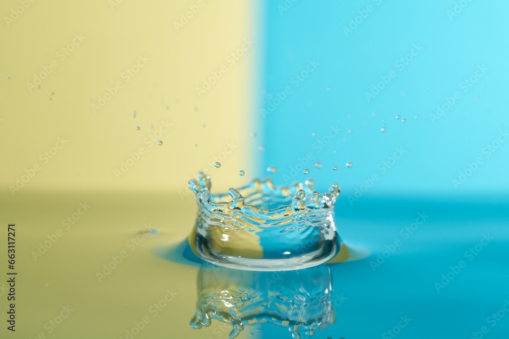 Group of colorful water droplets fall and bounce on a water surface Group of colorful water droplets fall and bounce on a water surface