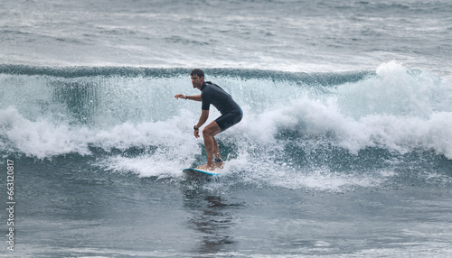 Surfer riding on a broken wave