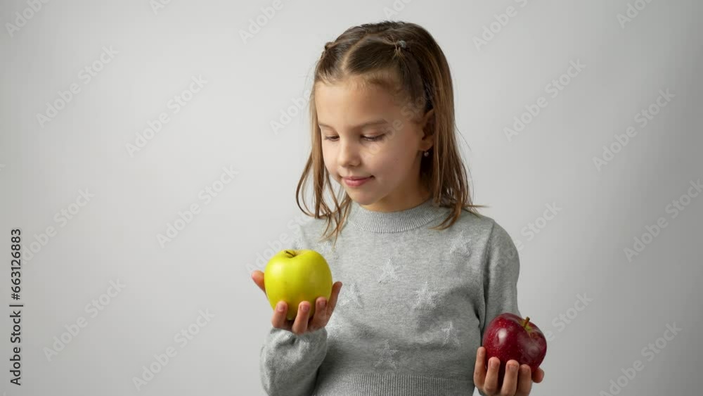 Cute girl choosing green apple between red apple Cute girl choosing green apple between red apple