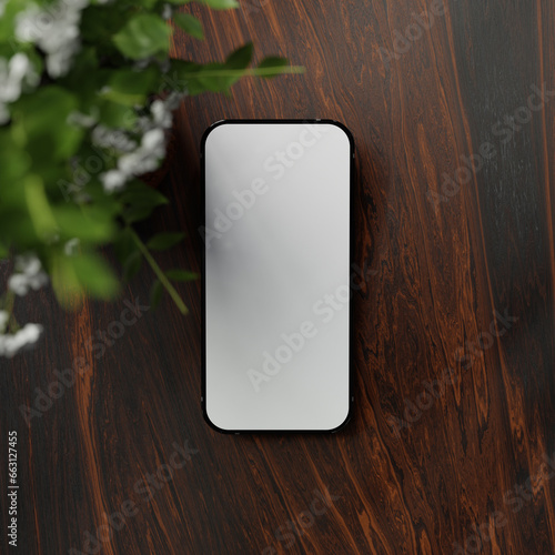 Top view of smartphone with blank white screen and indoor plant on wooden table