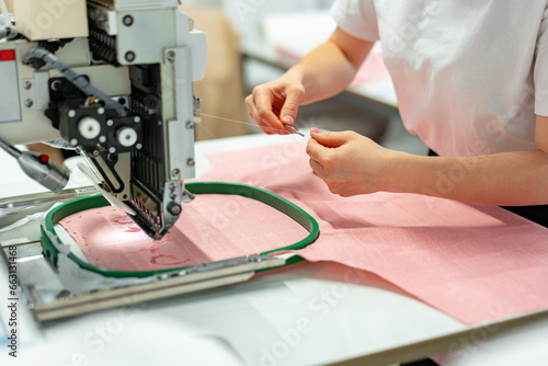 Close up of embroidery machine making patterns on textiles