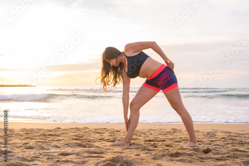 Woman stretching before running on the beach