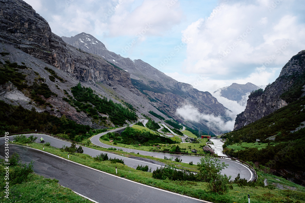 Asphalt serpentine road in Alps mountains. Road trip concept. Beautiful landscape.